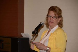Woman speaking at podium with microphone
