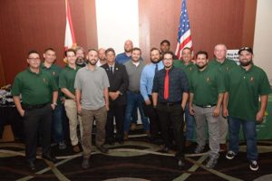 Group of men posing indoors with flags