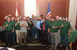 Group of men posing with flags, thumbs up