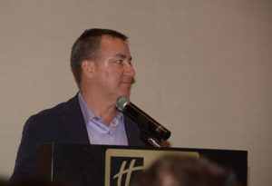 Man speaking at podium with microphone