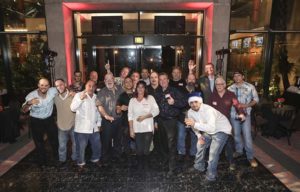 Group of adults posing in hotel lobby