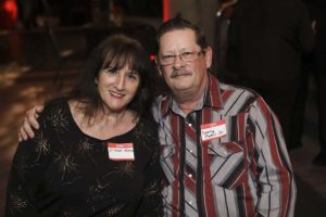 Smiling couple wearing name tags at event