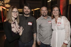 Four people with name tags at event