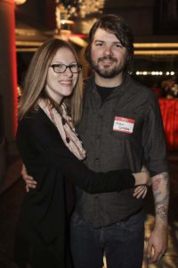 Smiling couple hugging at indoor evening event