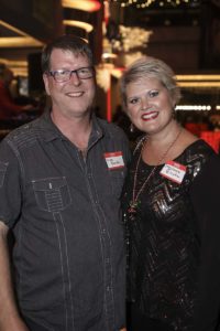 Smiling man and woman wearing name tags