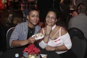 Two people smiling at table with dessert