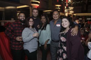 Group of smiling adults at indoor party