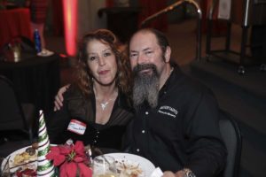 Couple smiling at table during holiday event