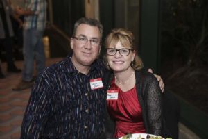 Smiling couple with name tags at event