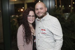 Smiling couple wearing name tags at event