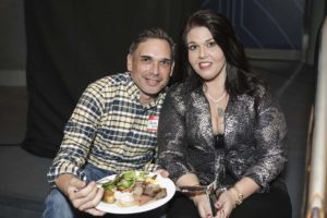 Smiling couple with plate of food