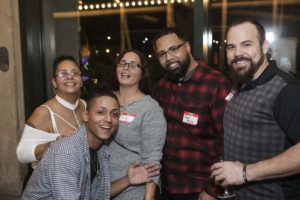 Group of five friends smiling at party