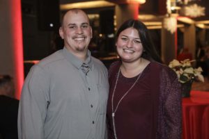 Smiling couple posing at festive indoor event