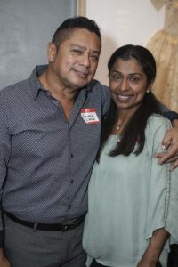 Smiling couple posing with arm around