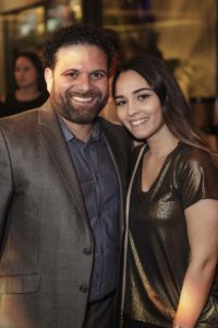 Man and woman smiling at indoor event