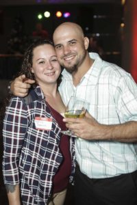 Smiling couple holding wine glass at party