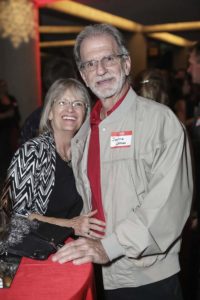 Smiling older couple at indoor social gathering