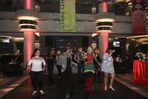 Group of people dancing in festive indoor venue