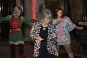 Three women dancing at an indoor party