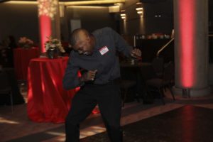 Man dancing at indoor party with red lighting