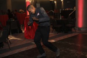Man dancing energetically at indoor event