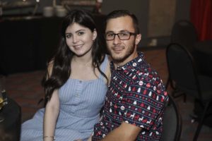 Smiling young couple seated at event