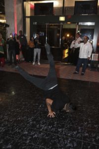 Breakdancer performing a one-handed floor freeze