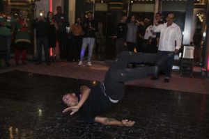 Breakdancer performing floor move at party