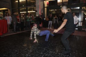 Couple dancing, one performing floor move