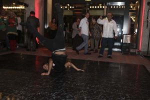 Breakdancer performing headspin on indoor dance floor