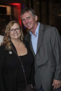 Smiling man and woman at social event
