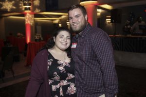 Smiling couple posing at decorated indoor party