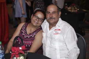 Smiling couple seated at festive event table
