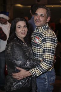 Couple embracing at indoor social event