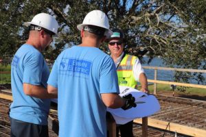 Construction workers reviewing blueprints on site