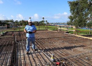 Construction worker on rebar deck near waterfront
