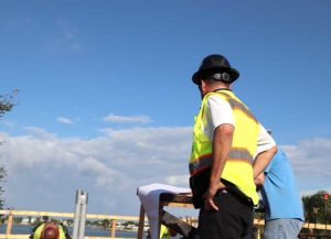 Construction worker in hi-vis vest reviewing plans