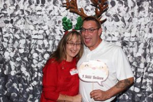 Couple wearing reindeer antlers at holiday photo