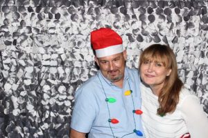 Smiling couple in holiday hat and lights