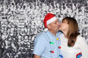 Couple kissing with Santa hat and Christmas lights