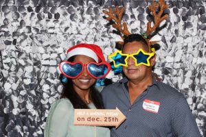 Couple in Christmas photo booth with props