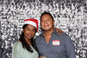 Smiling couple at holiday party with Santa hat