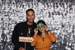 Couple in photo booth with green mask