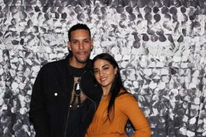 Couple posing against silver sequin backdrop