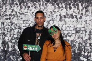 Two people posing in holiday photo booth