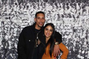 Man and woman smiling against silver petal backdrop