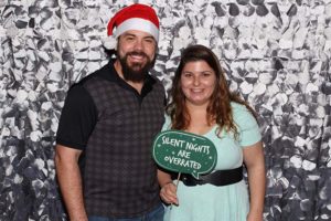 Smiling couple with humorous Christmas sign