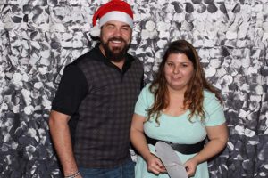 Smiling couple with Santa hat at photo booth