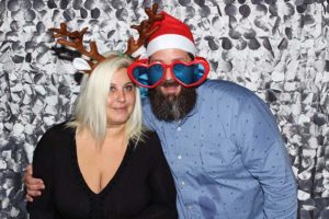Couple with reindeer antlers, Santa hat, glasses