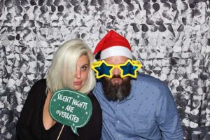 Couple wearing Santa hat and star glasses